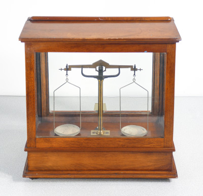 Bilancia da farmacia di precisione, teca in legno, con meccanismo di sollevamento dei piatti, cassetto e pesini. Italia, Fine Ottocento Primo Novecento