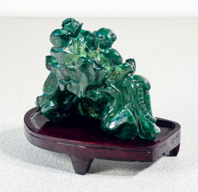 Buddha sorridente in malachite, con figure di bambini, basamento in legno. Cina