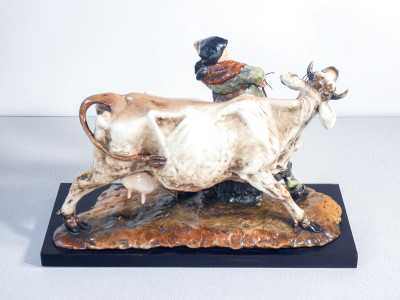 Scultura in ceramica dipinta e smaltata, firmata Guido CACCIAPUOTI. Contadina con mucca. Italia, Anni 30/40