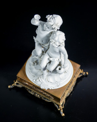Scultura in porcellana biscuit a firma BENACCHIO, della manifattura TRIADE, Putti baccanti. Bassano Italia, Anni 70